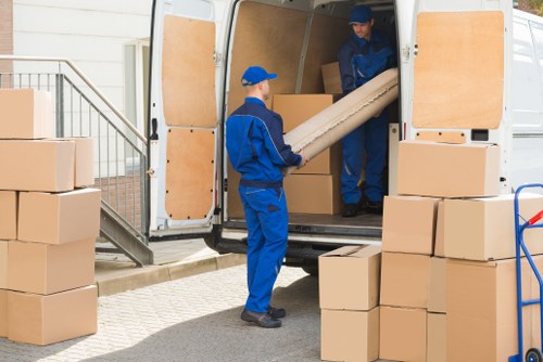 Professional team packing office equipment for relocation