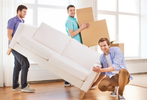 Professional removal team loading boxes into a moving truck